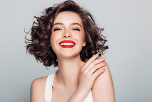 Brunette woman with short, loose corkscrew curls